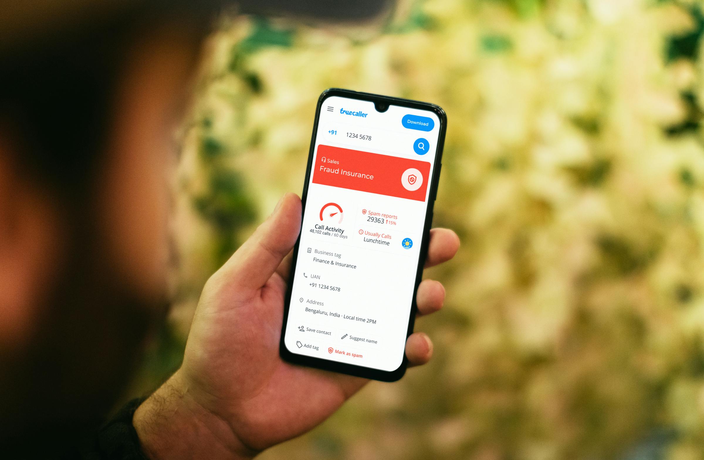 person looking at spam calls on phone