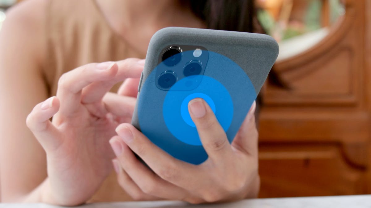 Person back tapping on a phone